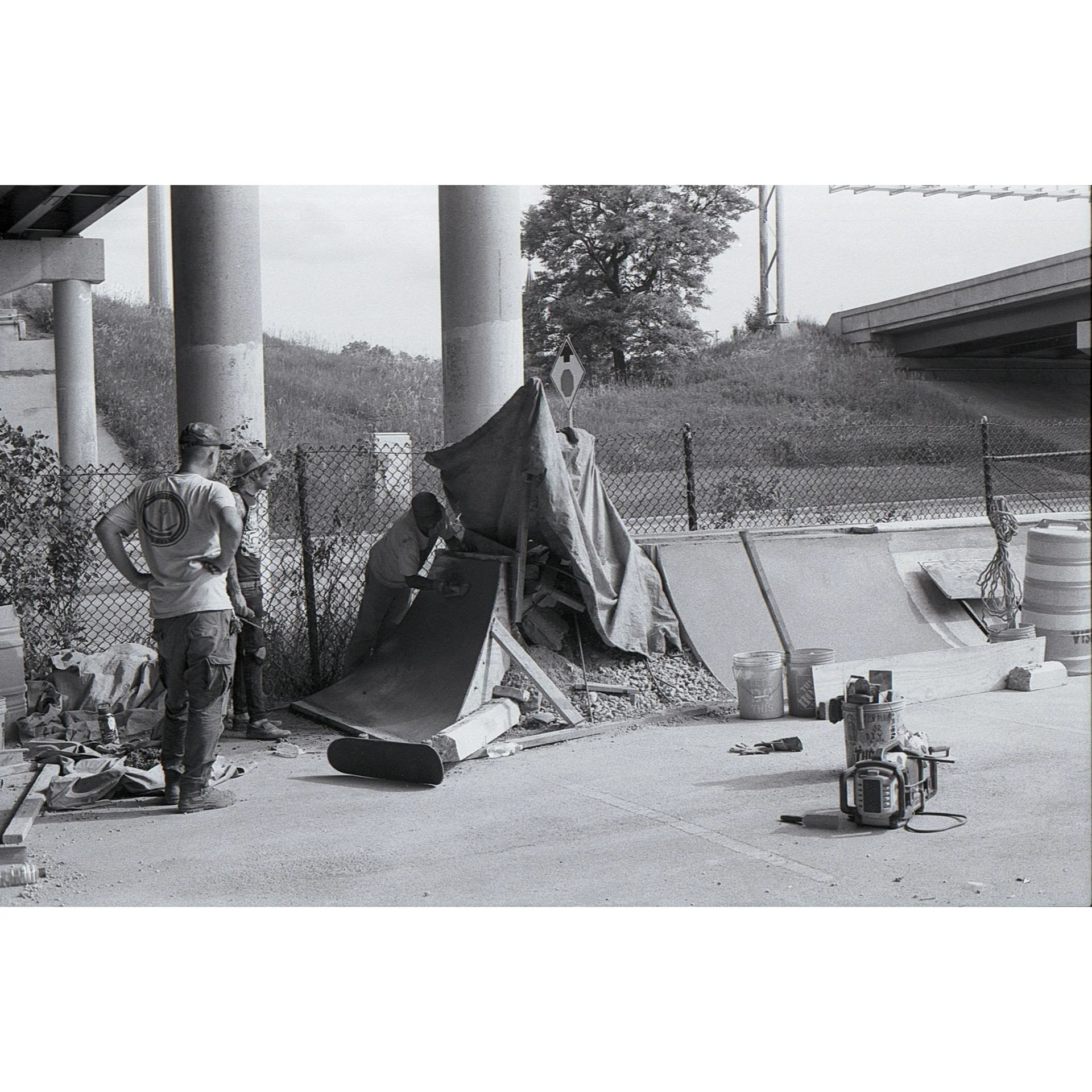 Black and white photo of a small build with a few skate community builders.